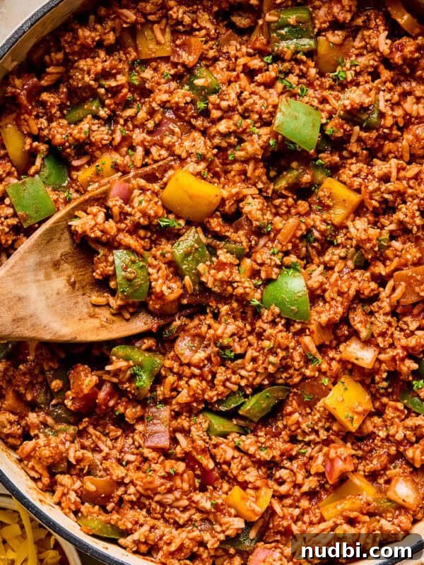 Creamy Chicken Orzo Skillet with Garlic and Parmesan 13 Simple ground turkey pepper skillet dinner in pan with wooden spoon.