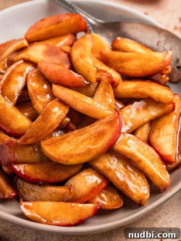 Crisp Apple and Arugula Salad with Honey Dijon Dressing 10 Plate with cinnamon sugar apples and serving utensil.