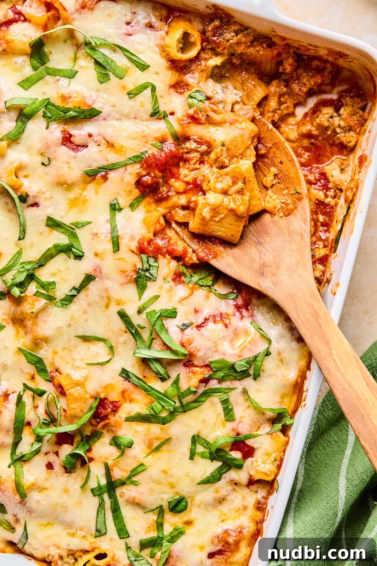 Cheesy Italian Sausage Pasta Bake with Roasted Tomatoes 2 Pan with Italian sausage and ricotta pasta bake with spoon scooping in.