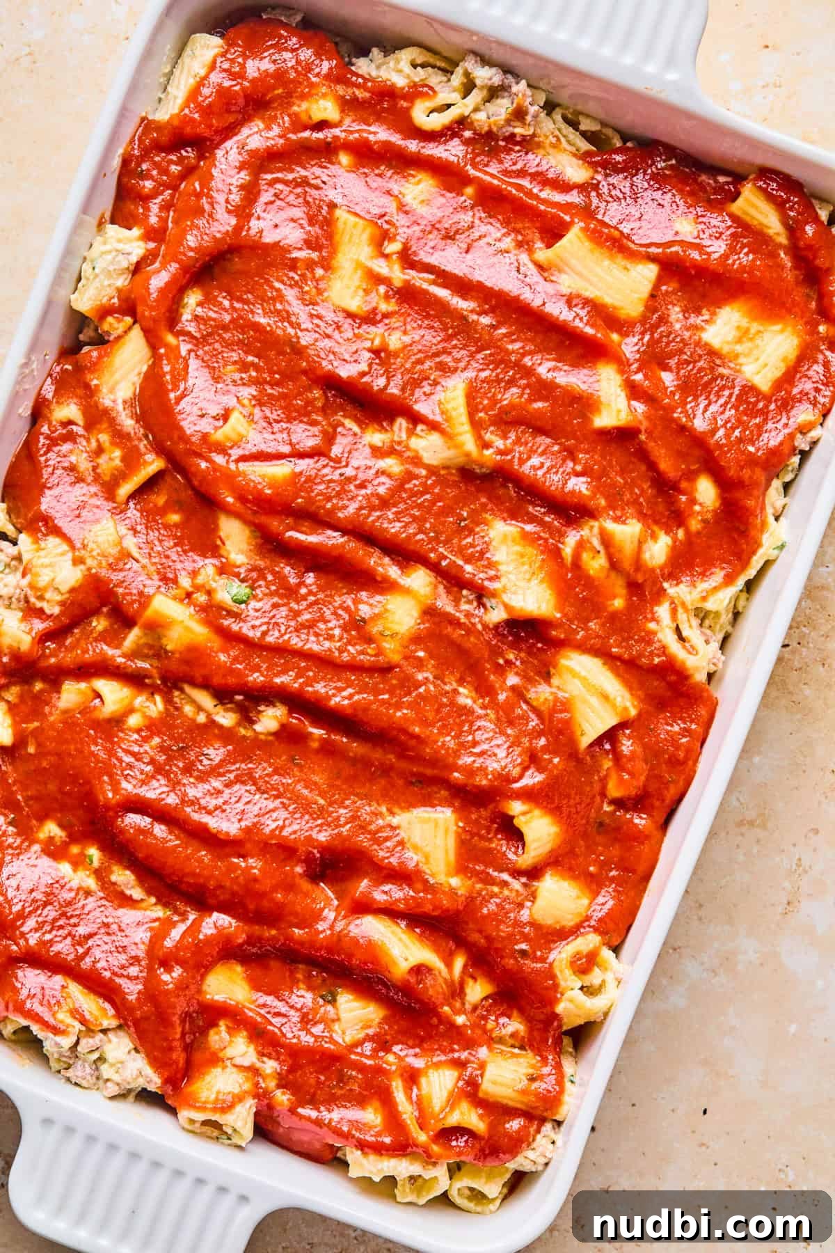 Cheesy Italian Sausage Pasta Bake with Roasted Tomatoes 12 Marinara spread on top of pasta.