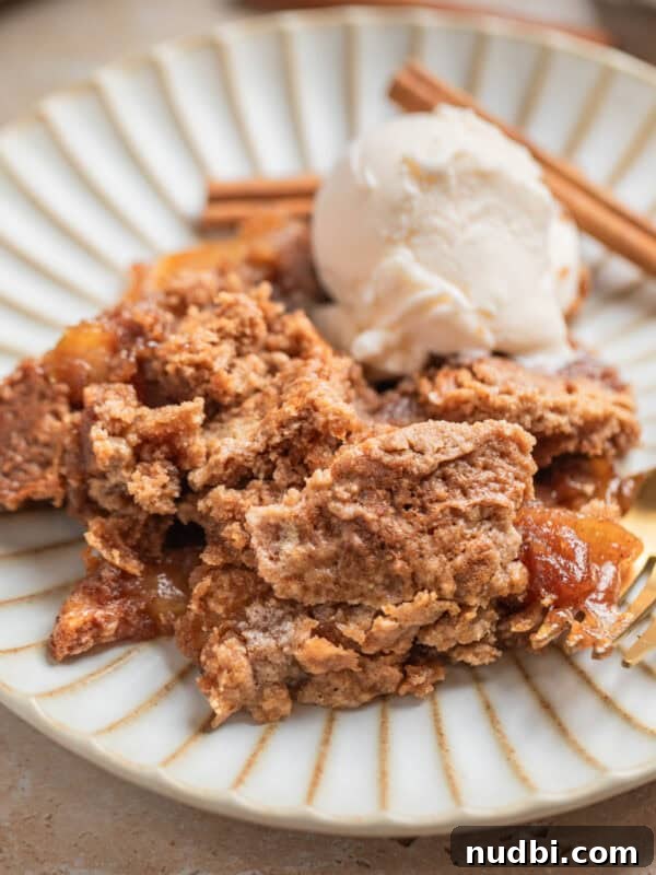 Crisp Puff Pastry Apple Tart Recipe for Homemade Dessert 9 Apple dump cake recipe scooped on dessert dish with scoop of vanilla ice cream and cinnamon sticks.