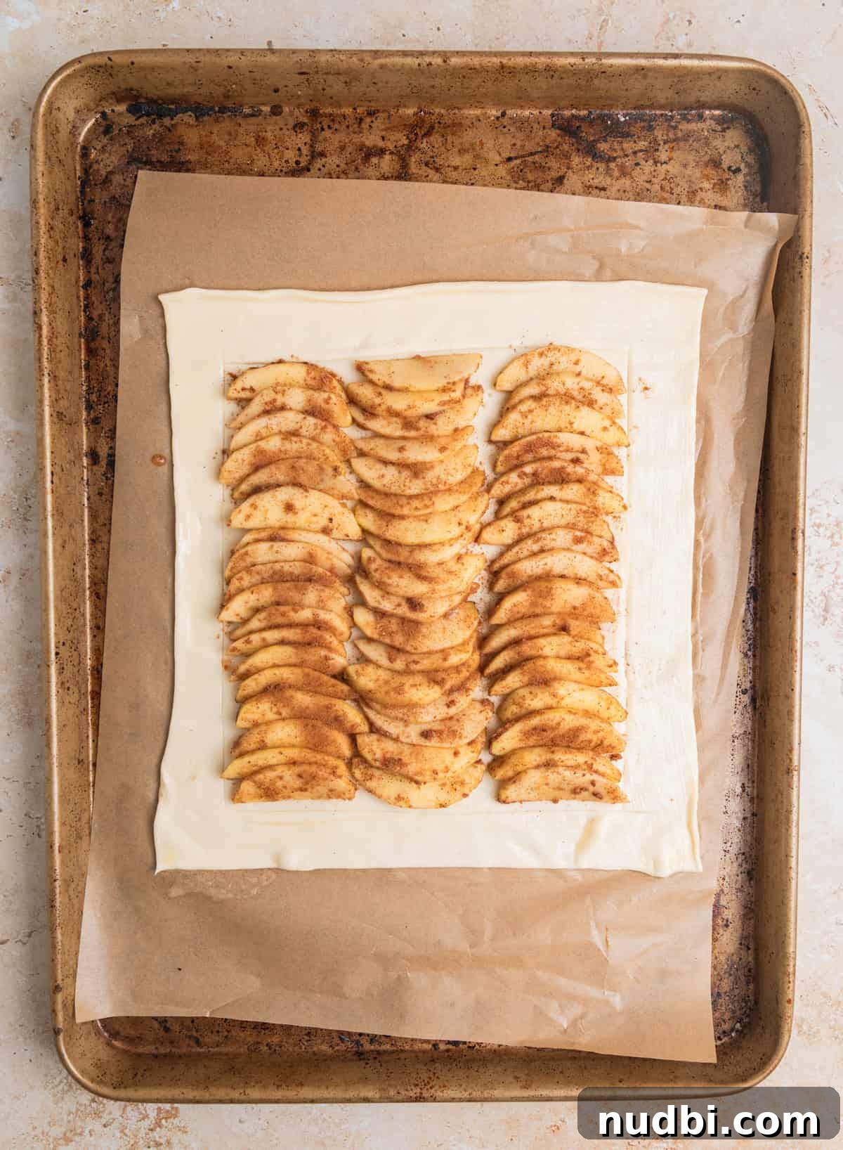 Crisp Puff Pastry Apple Tart Recipe for Homemade Dessert 6 Apple slices lined on scored puff pastry sheet.