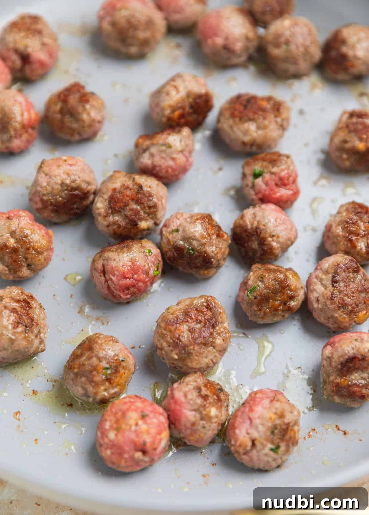 Hearty Vegetable and Meatball Soup Recipe for Cozy Meals 6 Seared meatballs in pan.