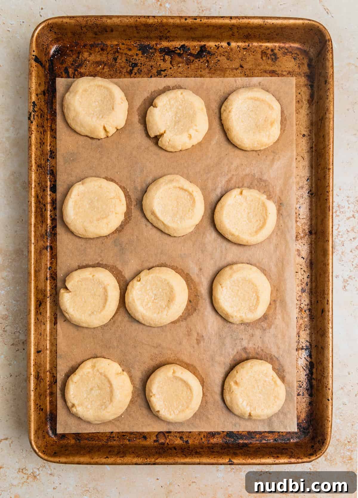 Nutella Thumbprint Cookies Recipe — Gooey Chocolate Hazelnut Treats 11 Baked thumbprint cookies on pan.