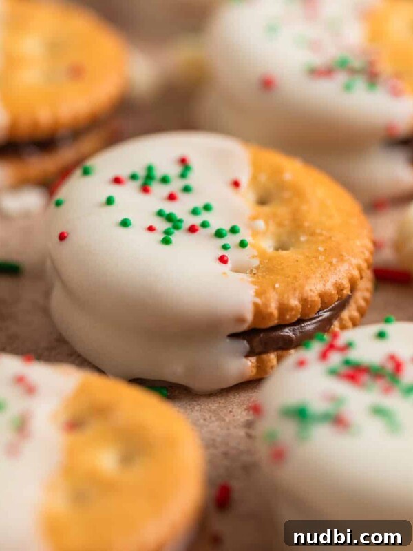 Nutella Thumbprint Cookies Recipe — Gooey Chocolate Hazelnut Treats 14 Nutella stuffed Ritz crackers dipped in white chocolate and covered with Christmas sprinkles.