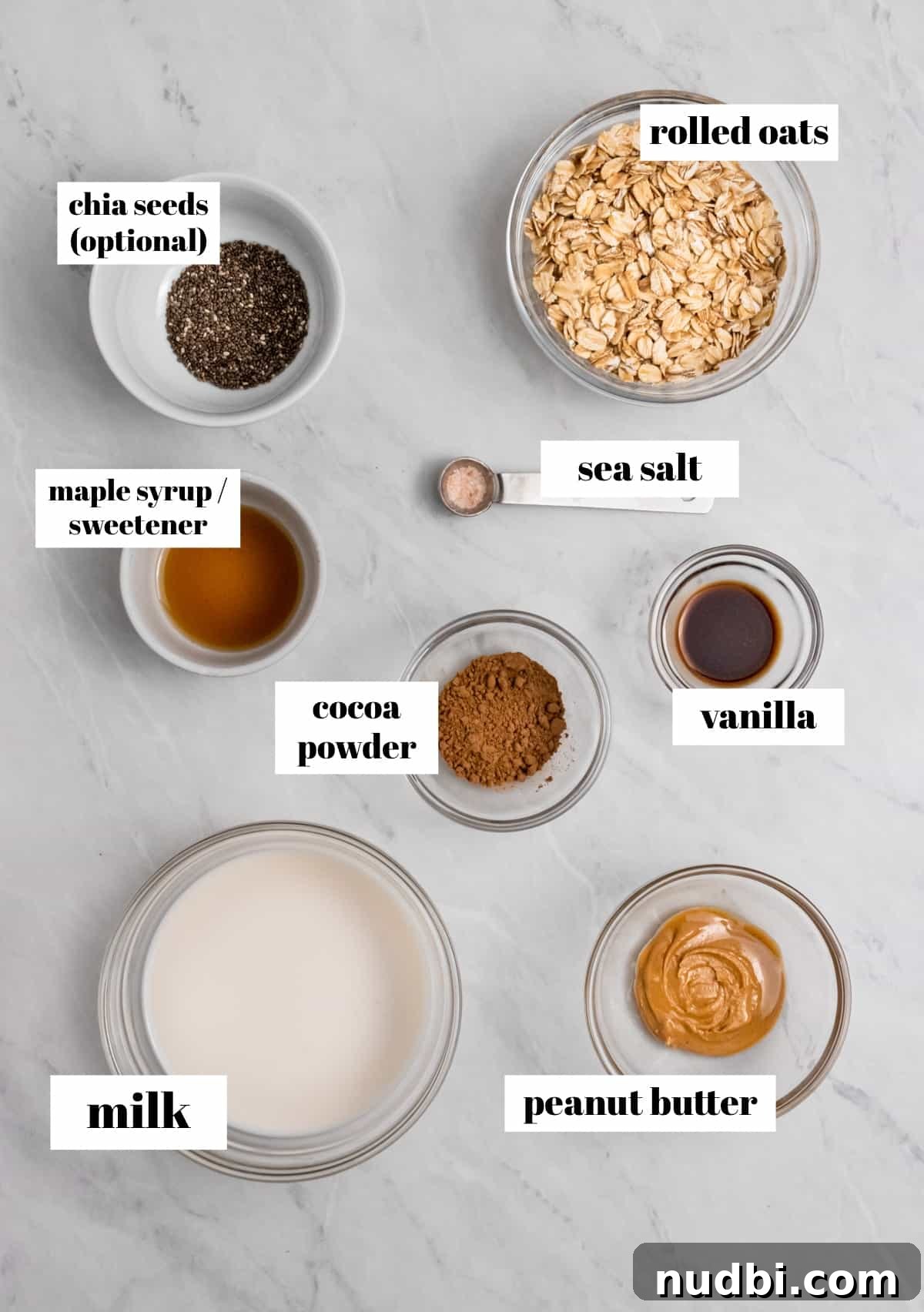 Chocolate Peanut Butter Overnight Oats Recipe for Creamy Breakfast 3 Rolled oats, cocoa powder, maple, and other ingredients in bowls on counter.