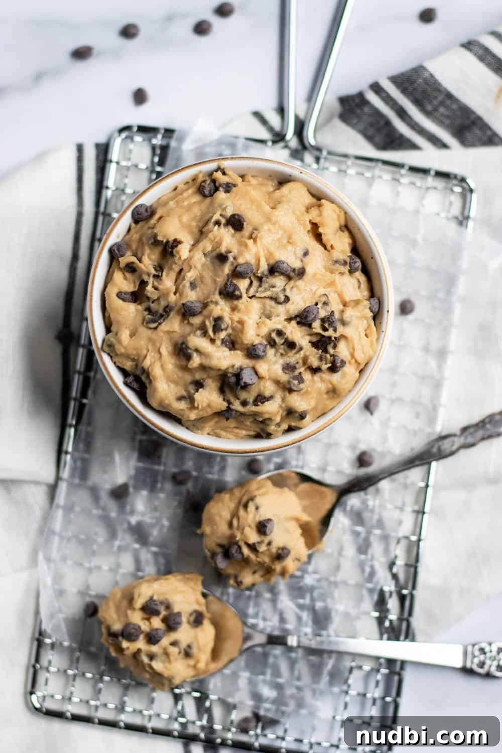 Vegan Chickpea Cookie Dough Recipe for Edible Dough Lovers 2 Bowl of cookie dough on wax paper with spoons.