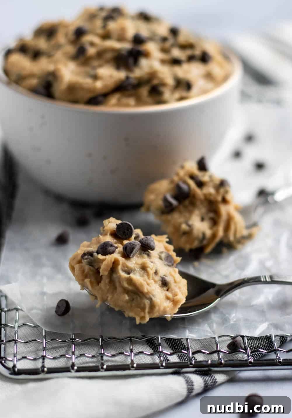 Vegan Chickpea Cookie Dough Recipe for Edible Dough Lovers 4 cookie dough on spoons in front of bowl.