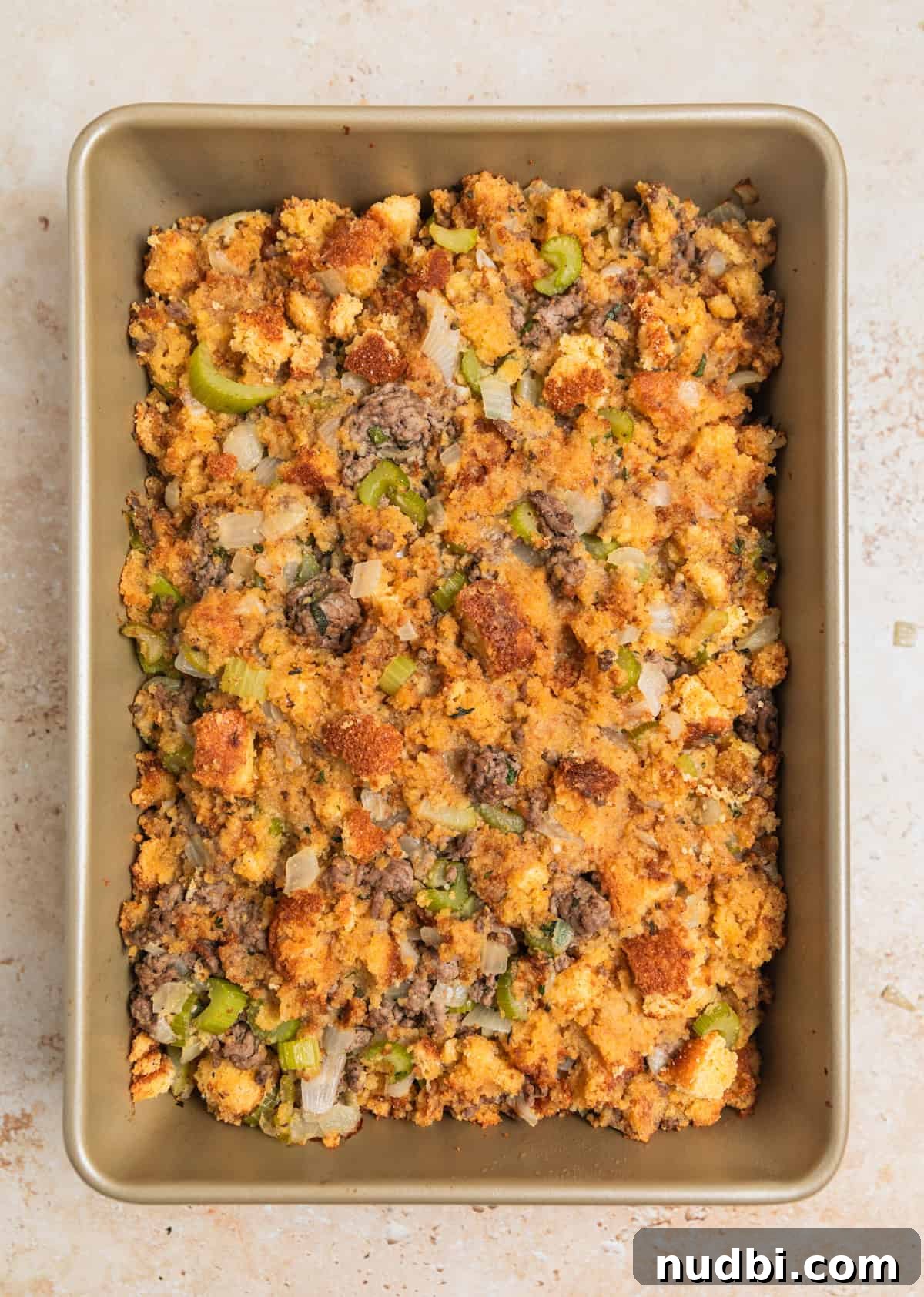 Savory Beef and Cornbread Stuffing Recipe for Holiday Dinners 8 Baked ground beef stuffing in pan.