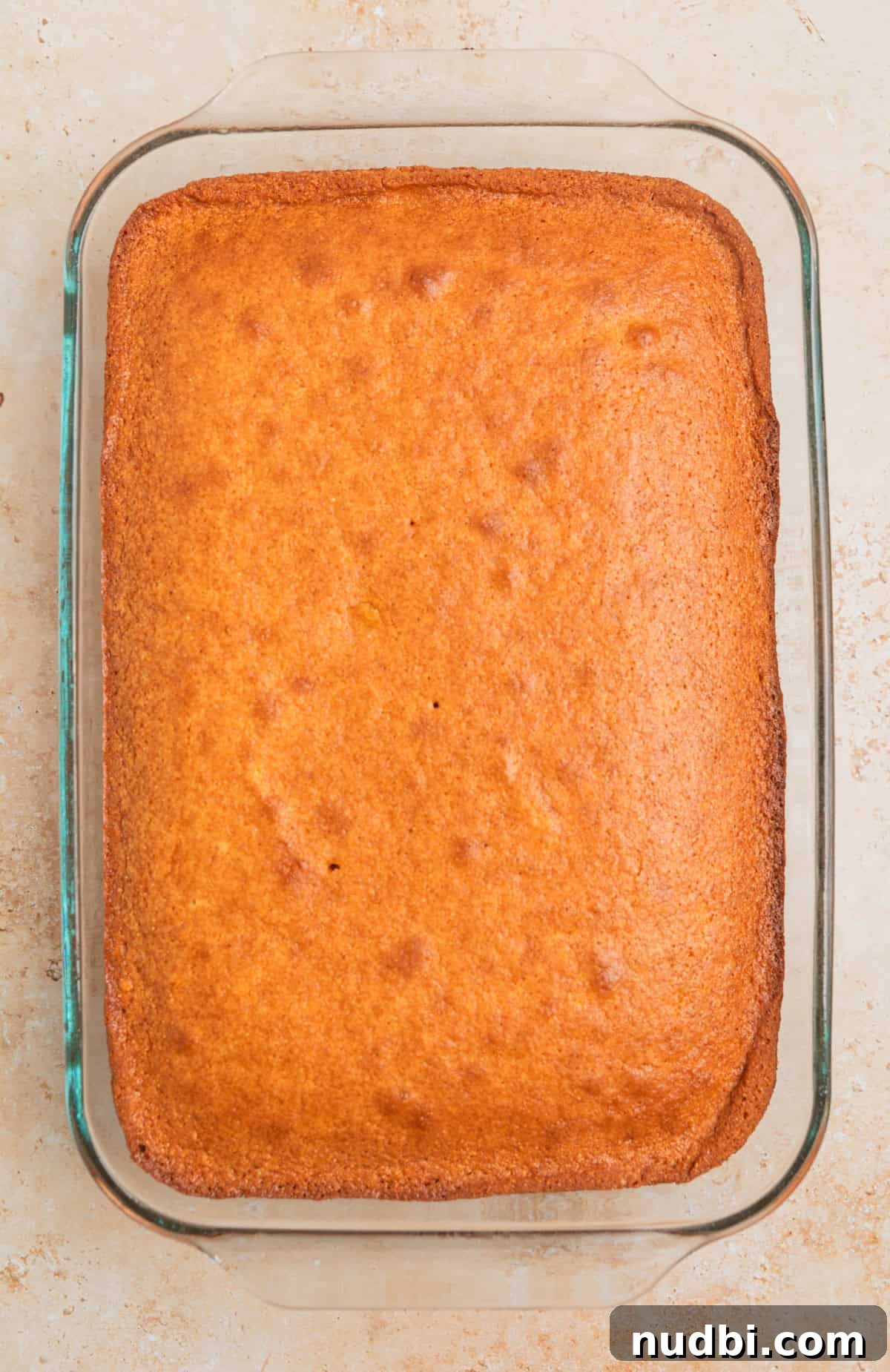 Savory Beef and Cornbread Stuffing Recipe for Holiday Dinners 3 Baked honey cornbread in glass baking pan.