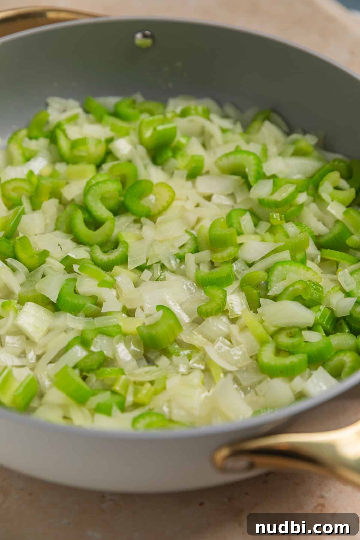 Savory Beef and Cornbread Stuffing Recipe for Holiday Dinners 5 Sautéed celery and onion in skillet.