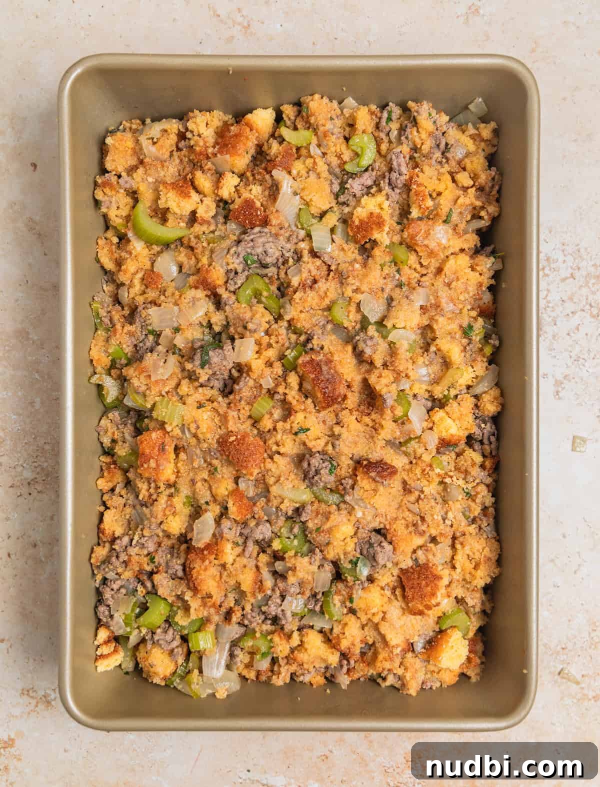 Savory Beef and Cornbread Stuffing Recipe for Holiday Dinners 7 Cornbread and beef stuffing mixture in baking pan before being cooked.