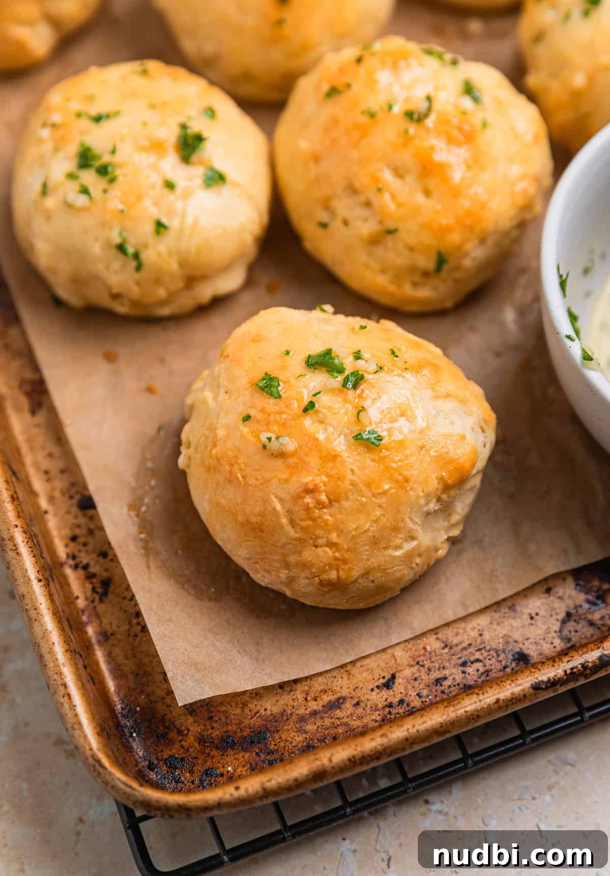 Quick No-Yeast Dinner Rolls Recipe for Soft, Fast Bread 13 Sheet pan with dinner rolls made without yeast topped with garlic herb butter.