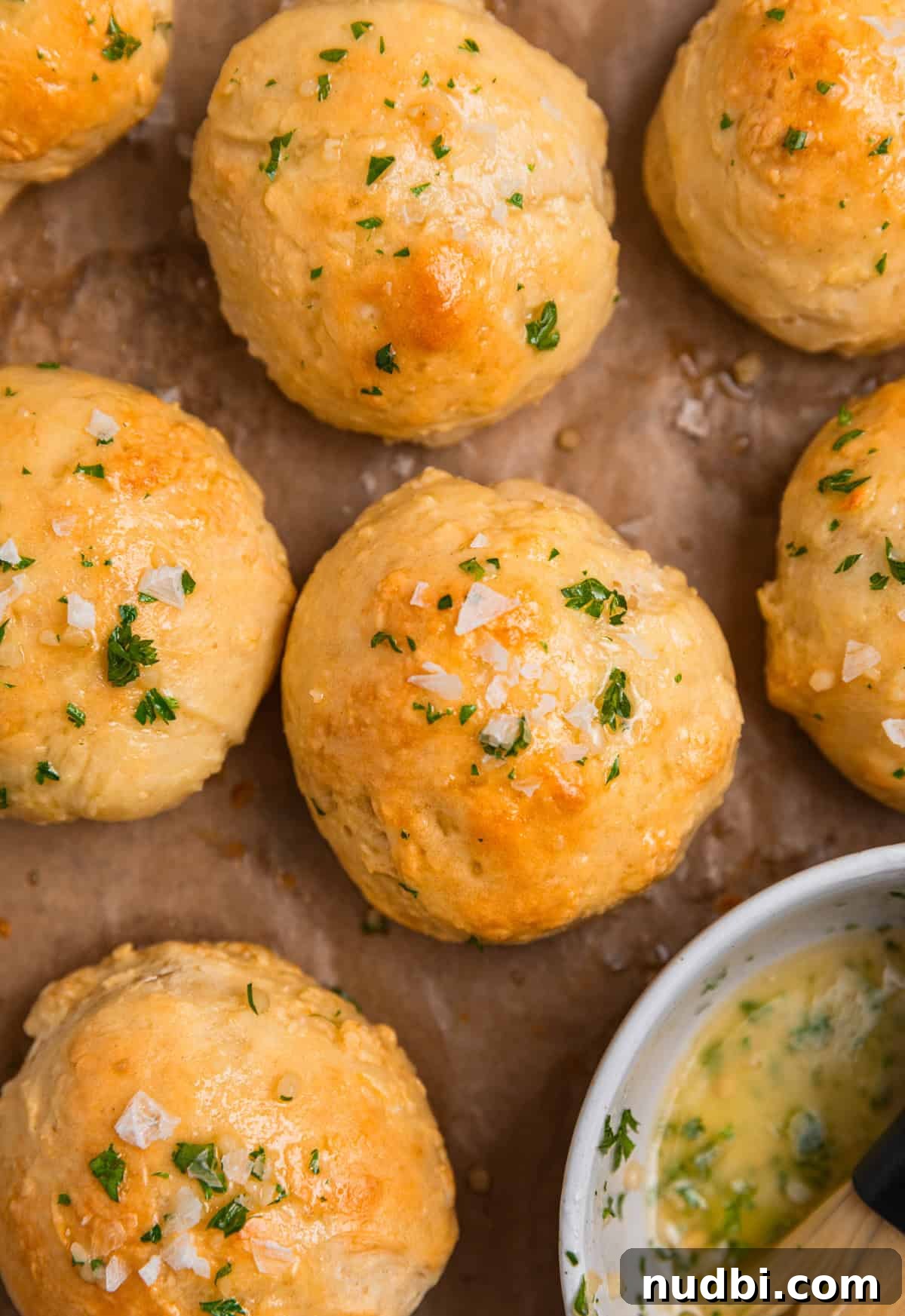 Quick No-Yeast Dinner Rolls Recipe for Soft, Fast Bread 3 Garlic herb butter in bowl next do dinner rolls.