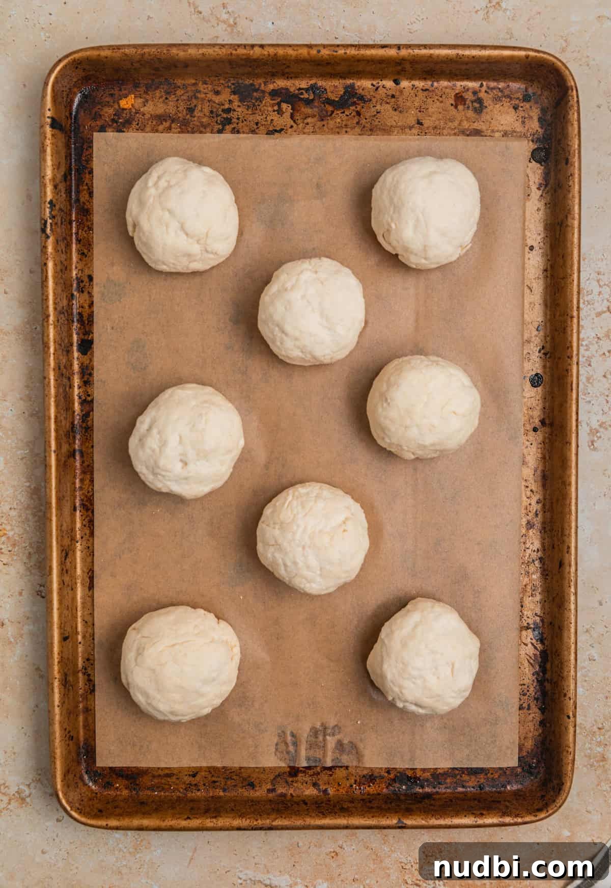 Quick No-Yeast Dinner Rolls Recipe for Soft, Fast Bread 8 Rolled Greek yogurt dinner rolls on parchment lined sheet pan.