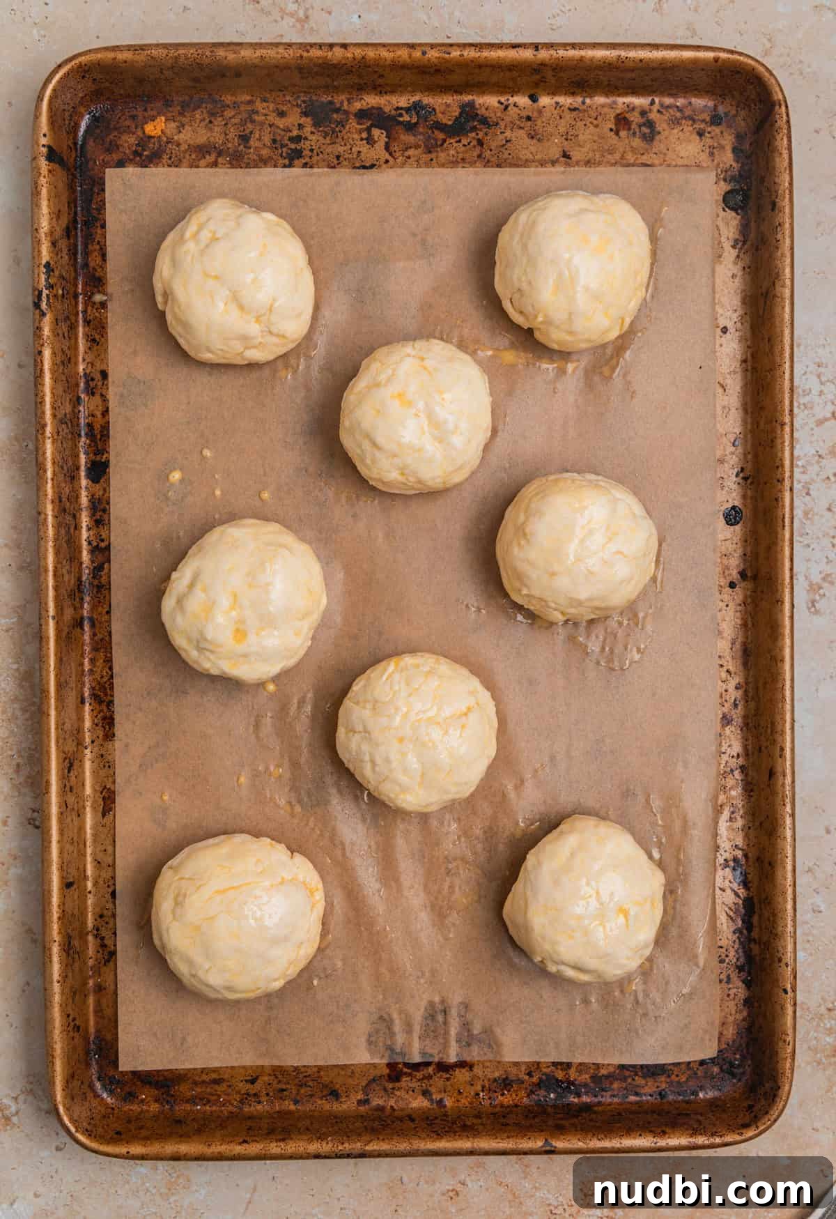 Quick No-Yeast Dinner Rolls Recipe for Soft, Fast Bread 9 Sheet pan with dinner rolls that have been brushed with egg wash.