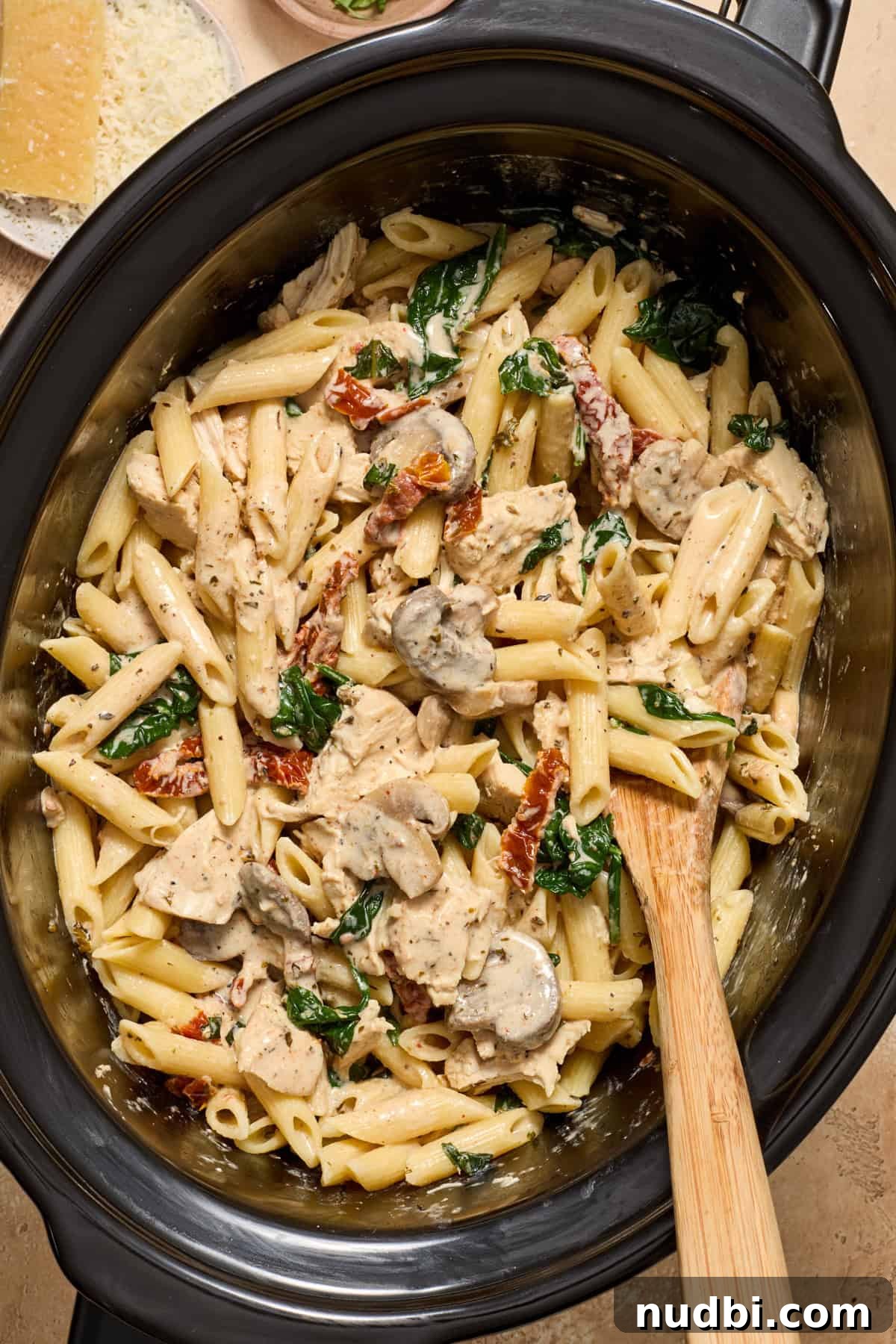 Creamy Slow Cooker Chicken Pasta Recipe 12 Pasta stirred into creamy chicken mixture in slow cooker.