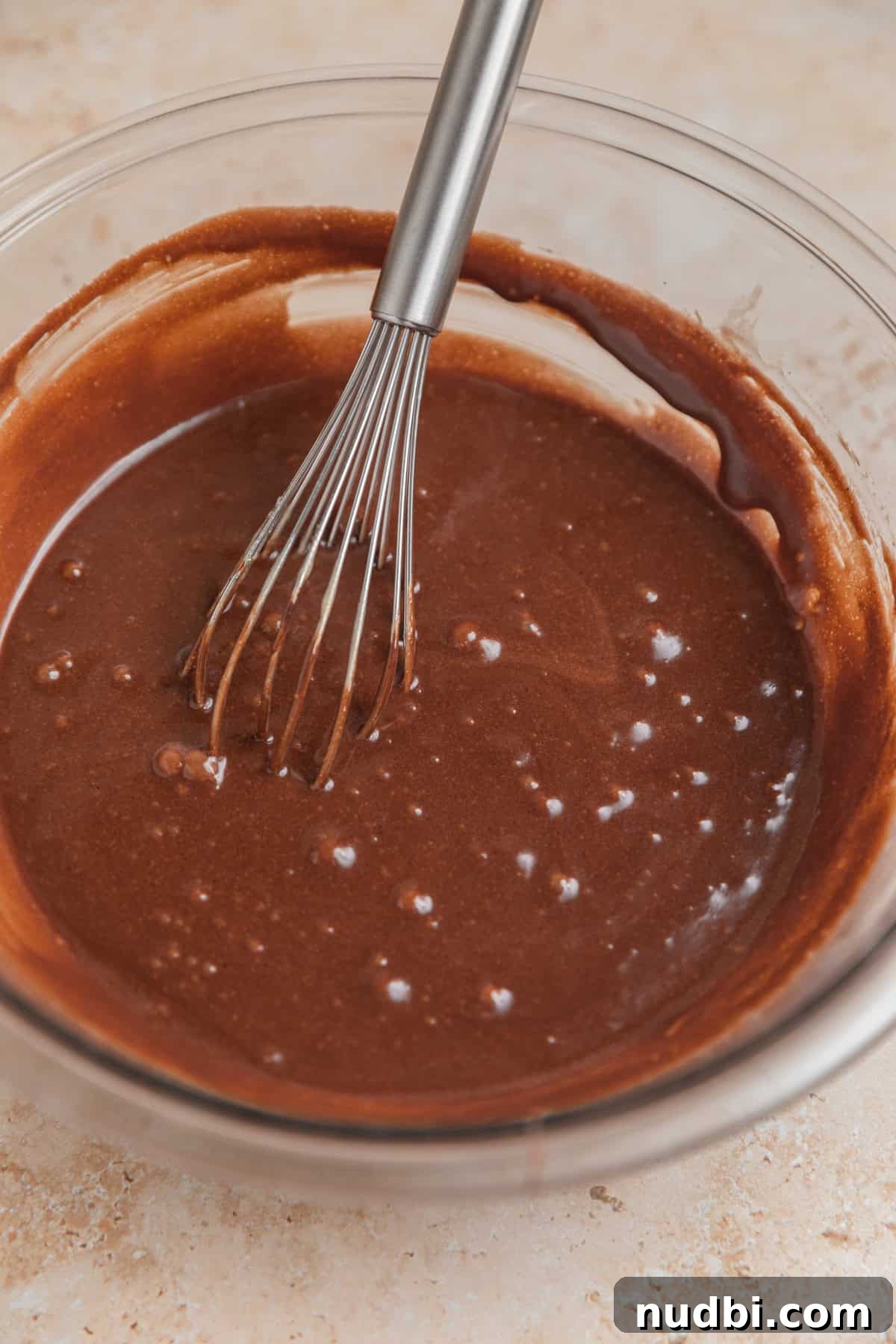 Peppermint Bark Brownies Recipe: Fudgy Chocolate Mint Bars 6 Melted chocolate mixed in bowl with whisk.