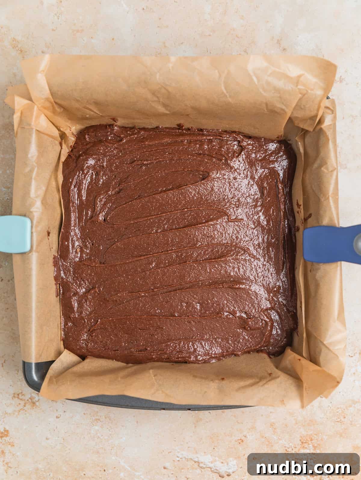 Peppermint Bark Brownies Recipe: Fudgy Chocolate Mint Bars 9 Peppermint bark brownie batter in parchment lined pan.