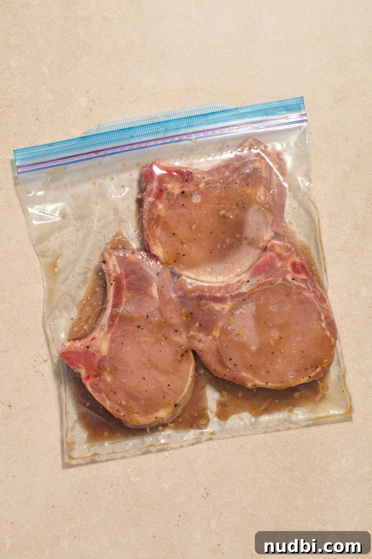 Crispy Sheet Pan Pork Chops with Roasted Vegetables 4 Bone-in pork chops in plastic bag with marinade.
