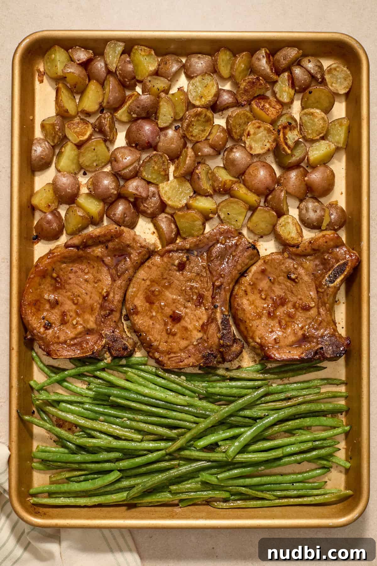 Crispy Sheet Pan Pork Chops with Roasted Vegetables 10 Sheet pan pork chops with potatoes and green beans cooked.