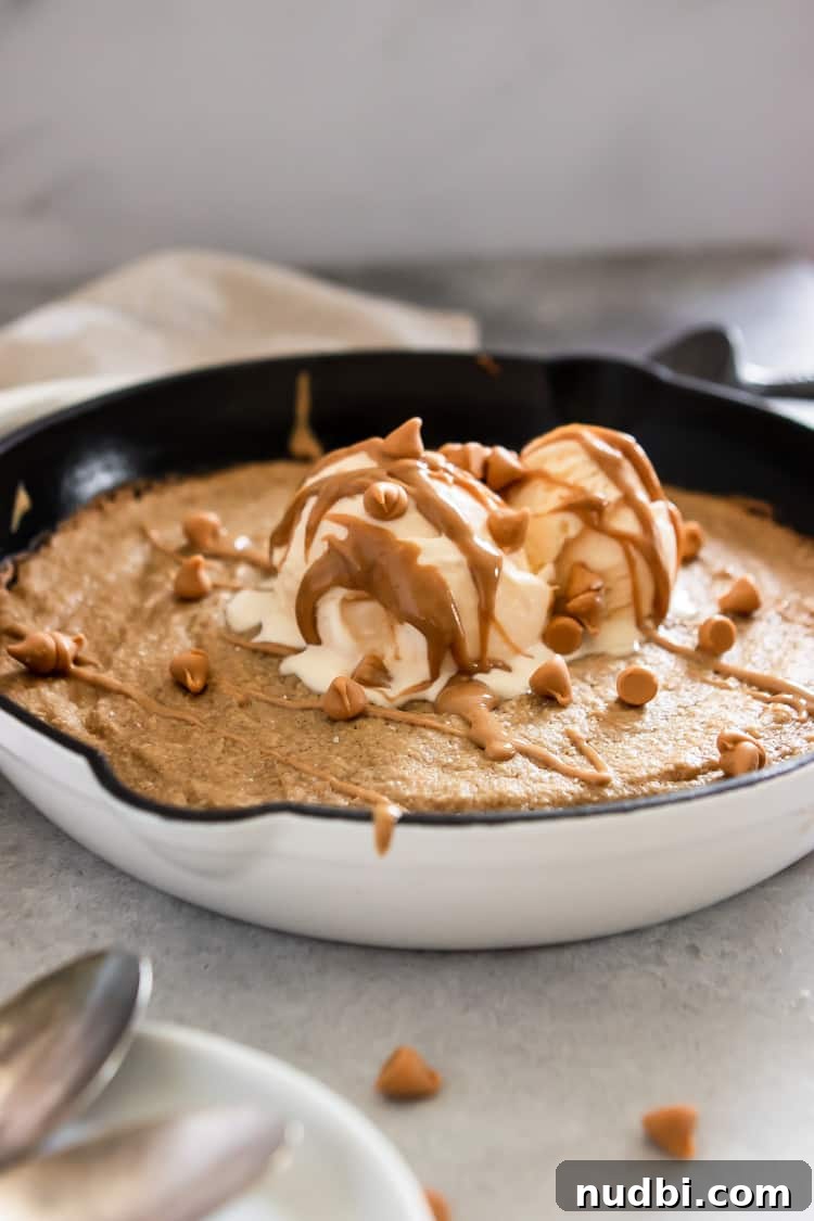 Salted Peanut Butter Skillet Cookie — Gluten Free Recipe 5 Peanut butter skillet cookie with vanilla ice cream and peanut butter drizzle.