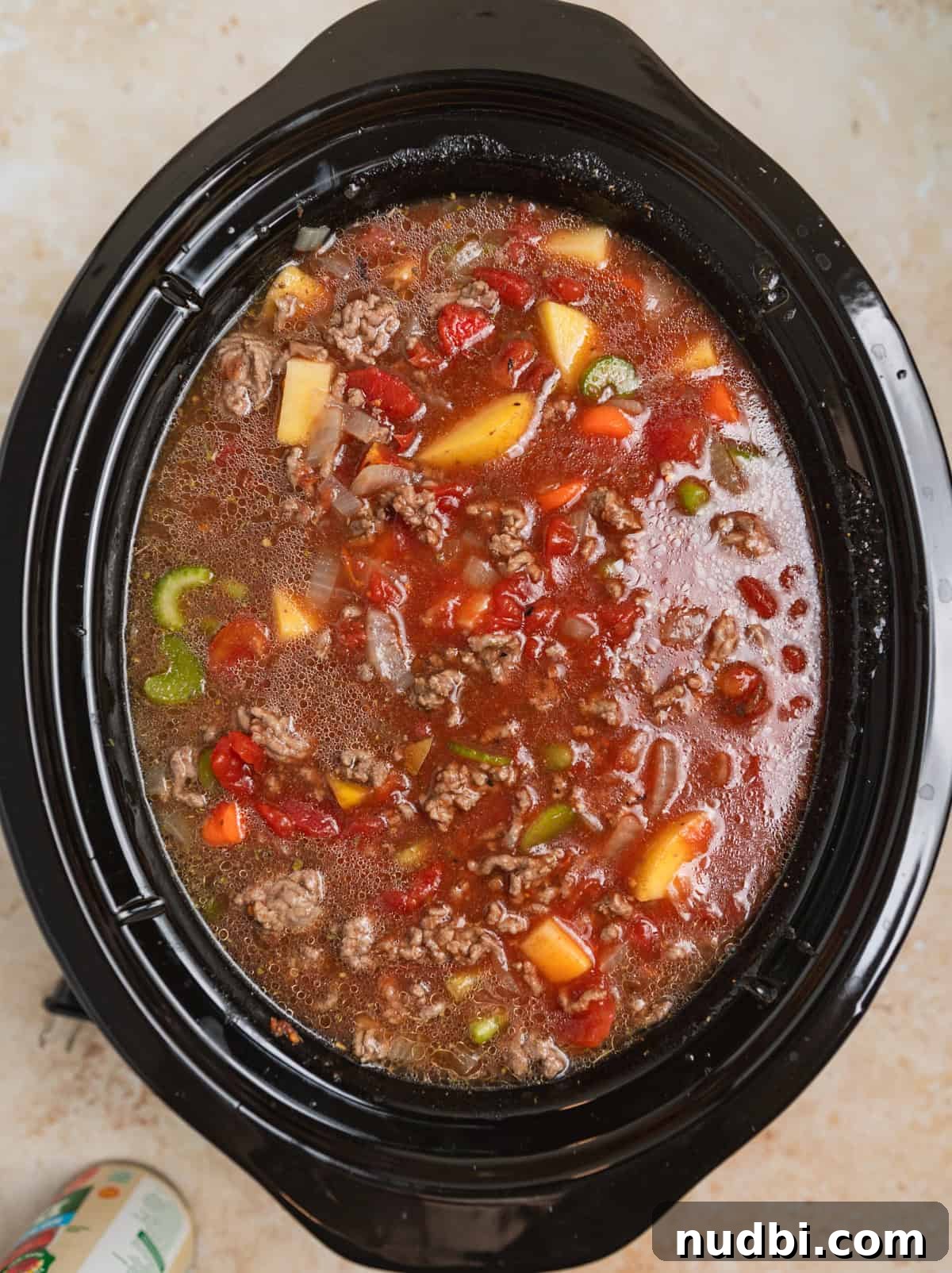 Slow Cooker Hamburger Soup Recipe for Hearty Weeknight Meals 5 Broth added to crockpot hamburger soup before cooking.
