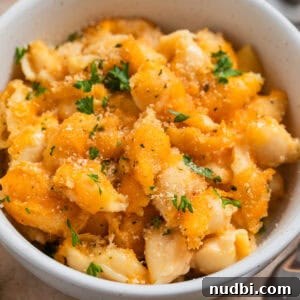 High-Protein Mac and Cheese Recipe for Muscle Gain 11 Bowl with protein mac and cheese with chopped parsley over top.