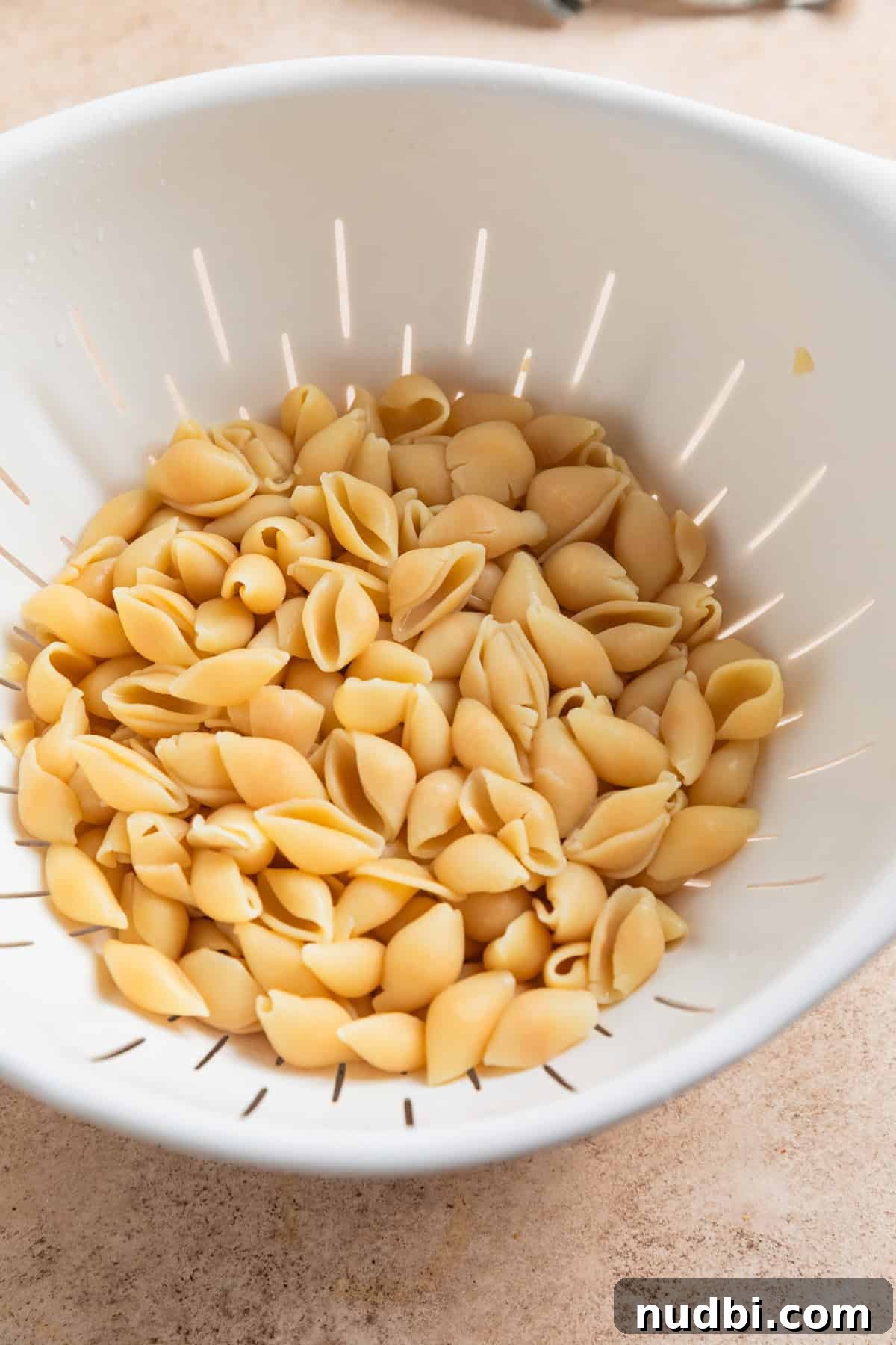 High-Protein Mac and Cheese Recipe for Muscle Gain 4 Protein pasta in colander after being cooked al dente.
