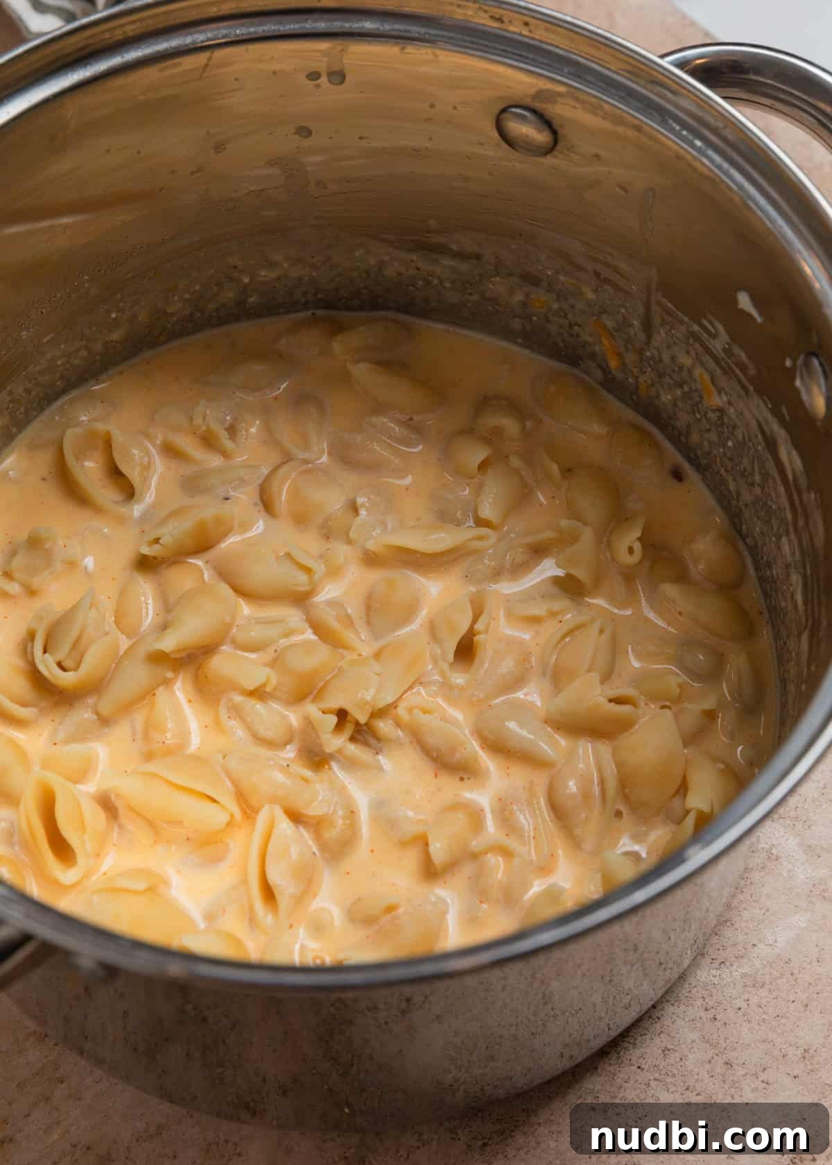 High-Protein Mac and Cheese Recipe for Muscle Gain 7 Pasta added and stirred into large pot with cheese sauce.