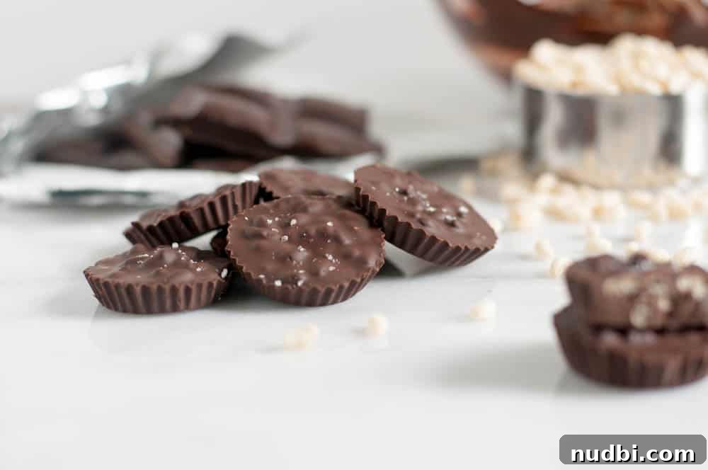 Chocolate Crunch Bar Cups Recipe with Crispy Chocolate Filling 3 Sea salt dark chocolate crispy cups with crispy cereal in background.