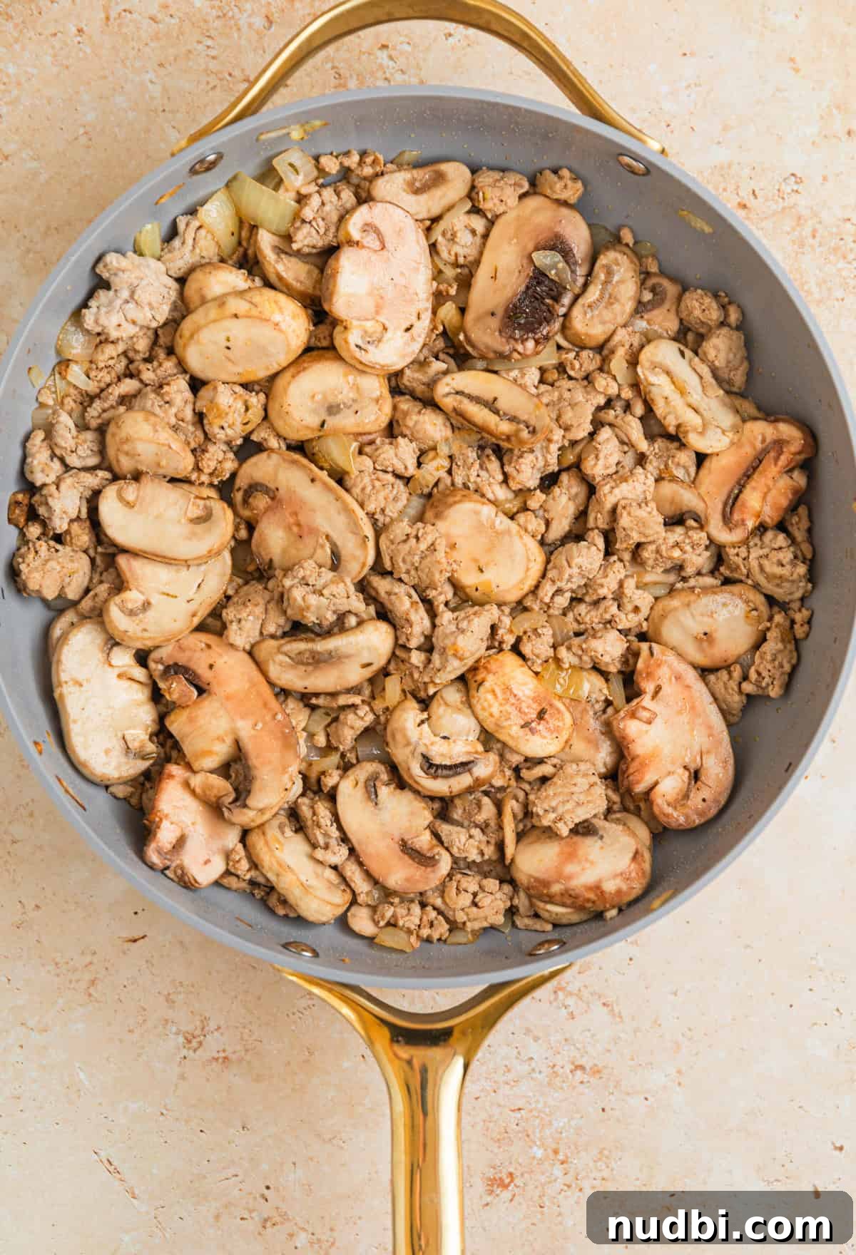 Creamy Ground Turkey Stroganoff Recipe for Weeknight Dinner 6 Mushrooms in skillet with browned ground turkey and onions.