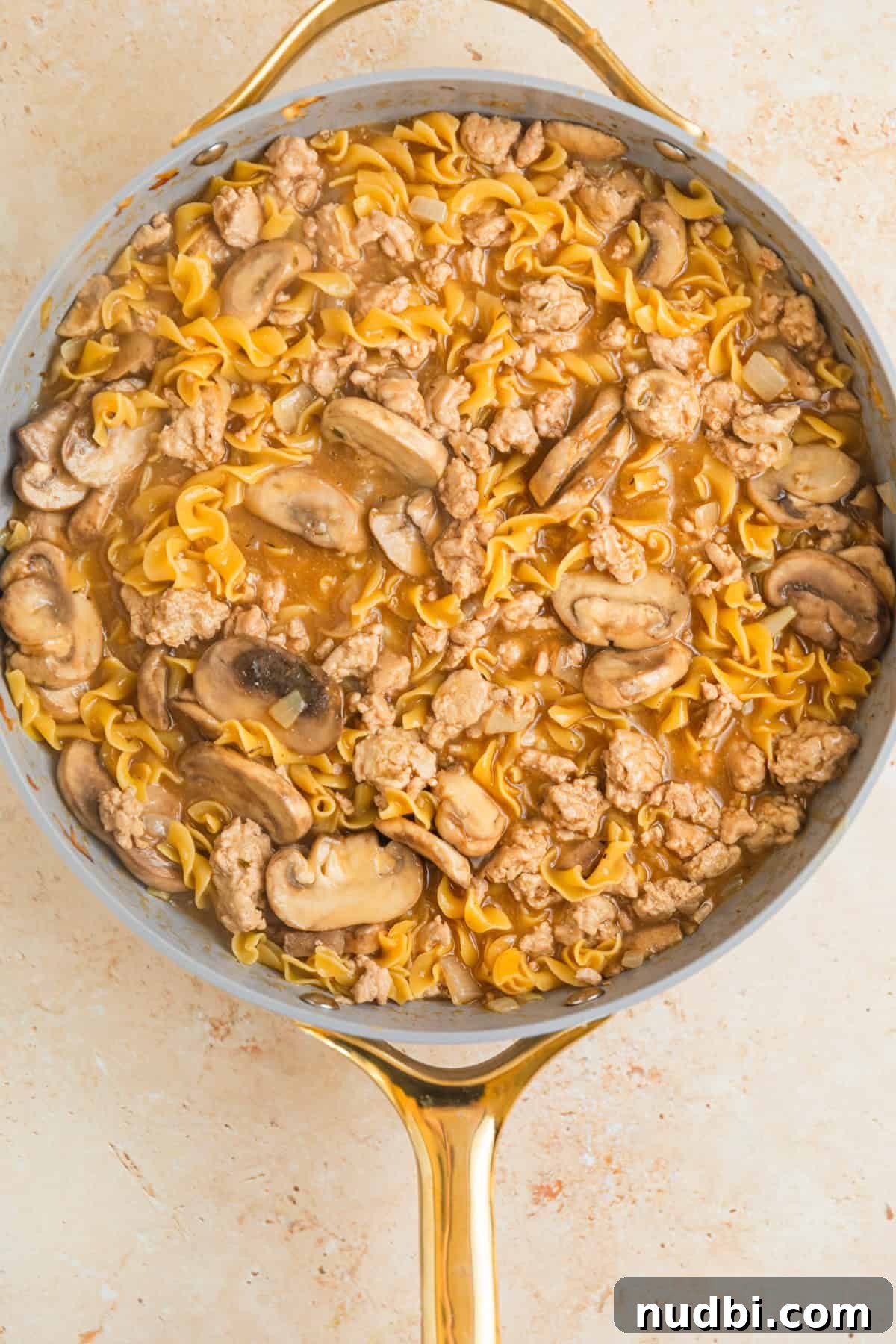 Creamy Ground Turkey Stroganoff Recipe for Weeknight Dinner 8 Cooked egg noodles in turkey stroganoff cooked in skillet.