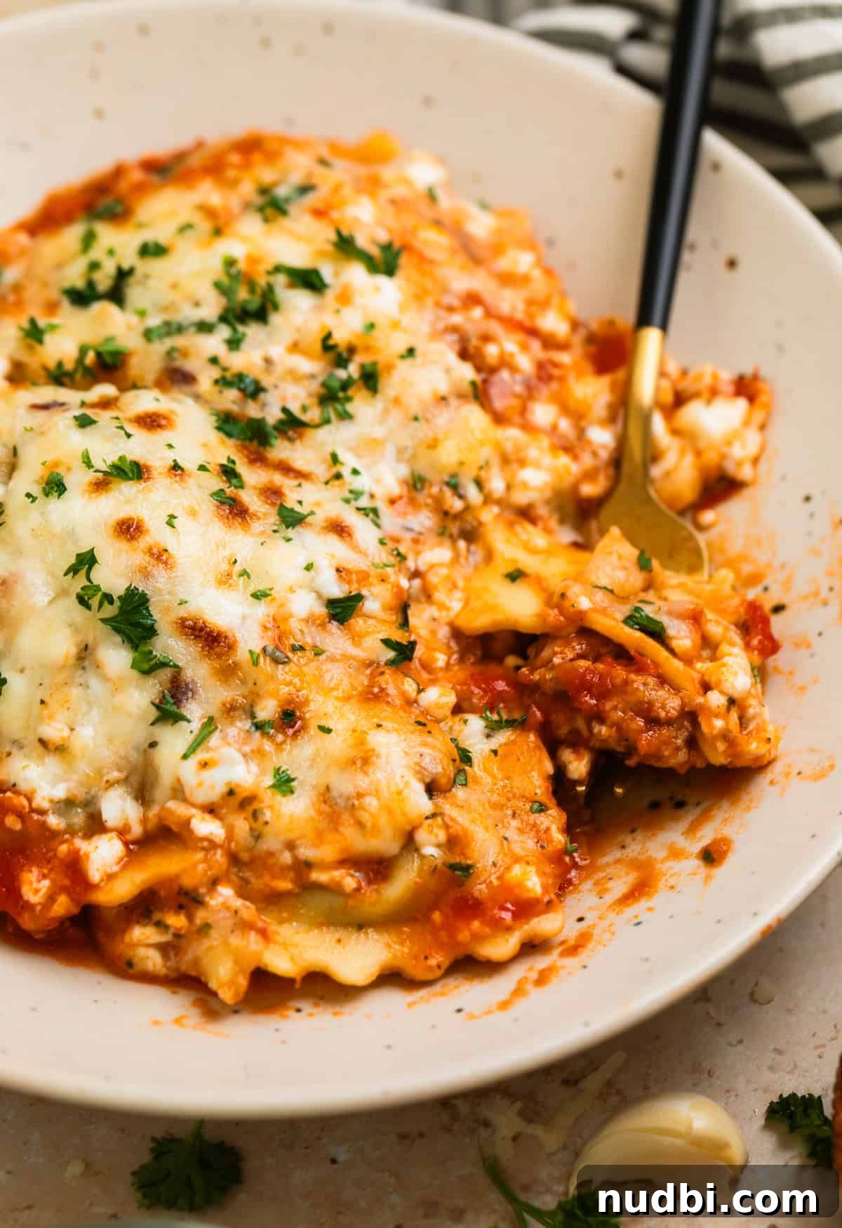 Skillet Ravioli Lasagna Recipe: Quick One-Pan Italian Dinner 2 Plate with skillet lasagna ravioli with fork scooping in.