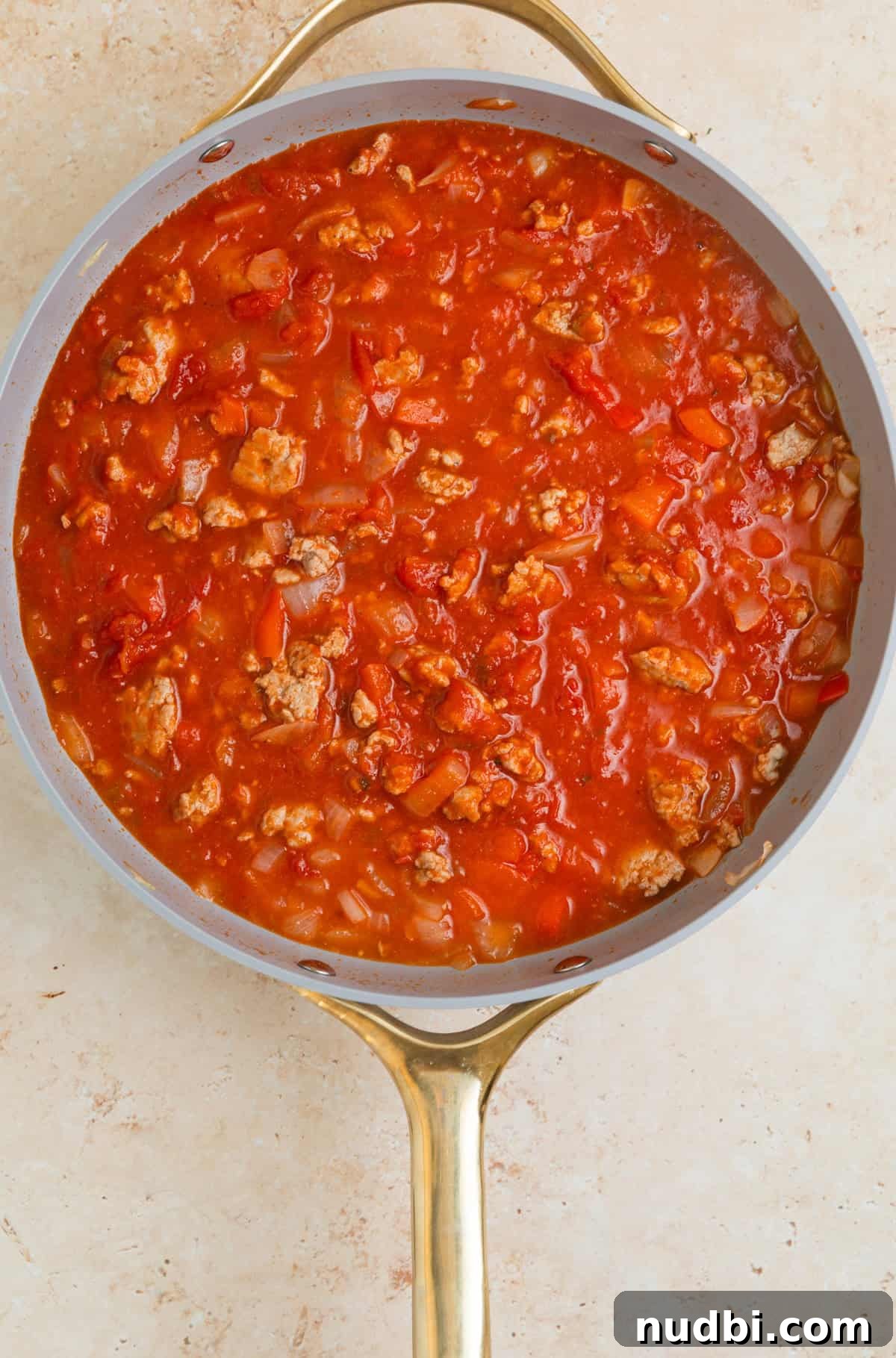 Skillet Ravioli Lasagna Recipe: Quick One-Pan Italian Dinner 7 Marinara added to skillet with browned turkey and veggies.