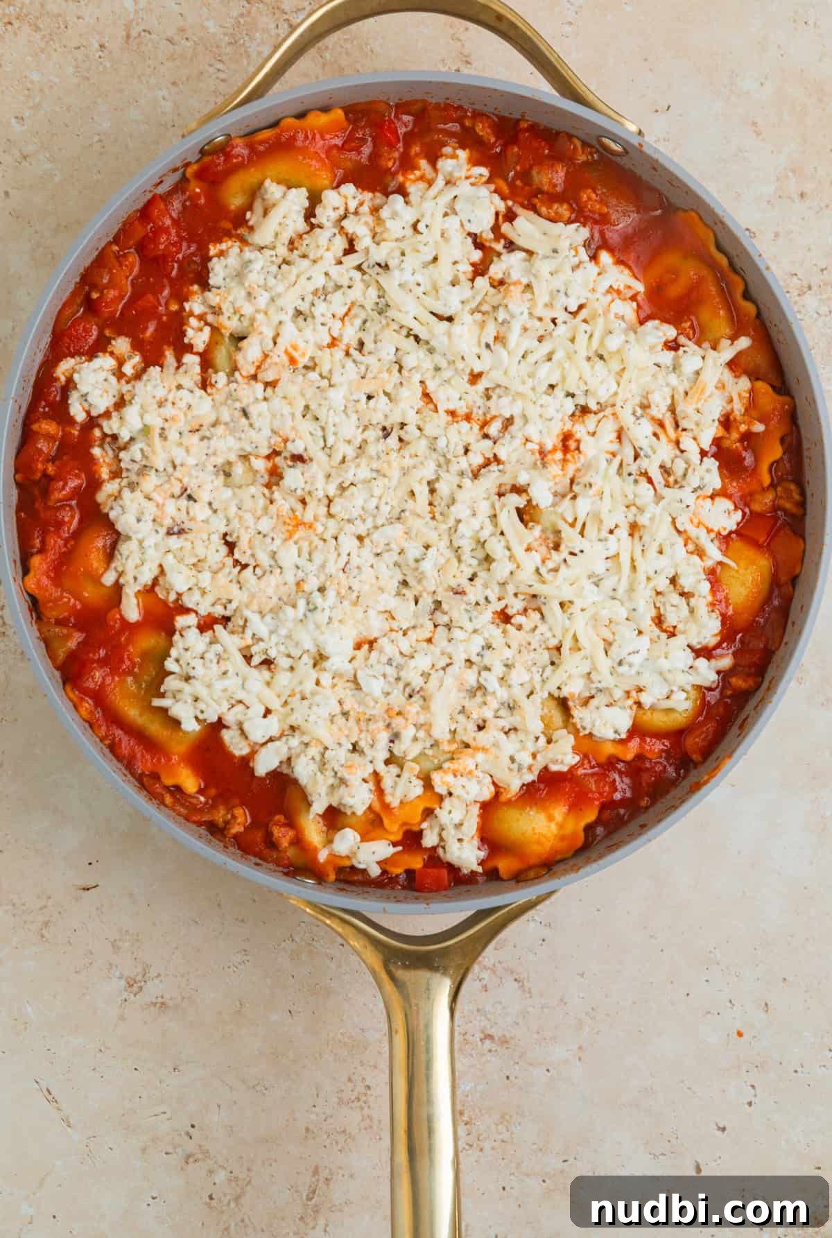 Skillet Ravioli Lasagna Recipe: Quick One-Pan Italian Dinner 10 Cottage cheese lasagna mixture spread over top of lasagna in skillet.