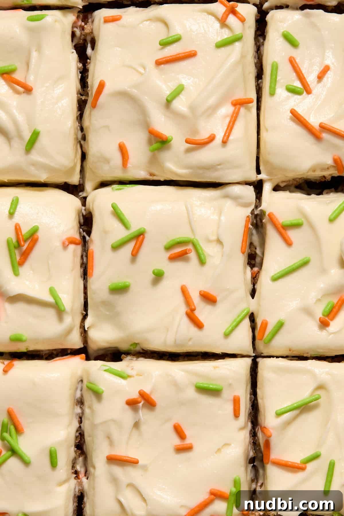 Moist Carrot Cake Recipe Using Cake Mix 2 Sliced carrot cake pieces topped with green and orange sprinkles.