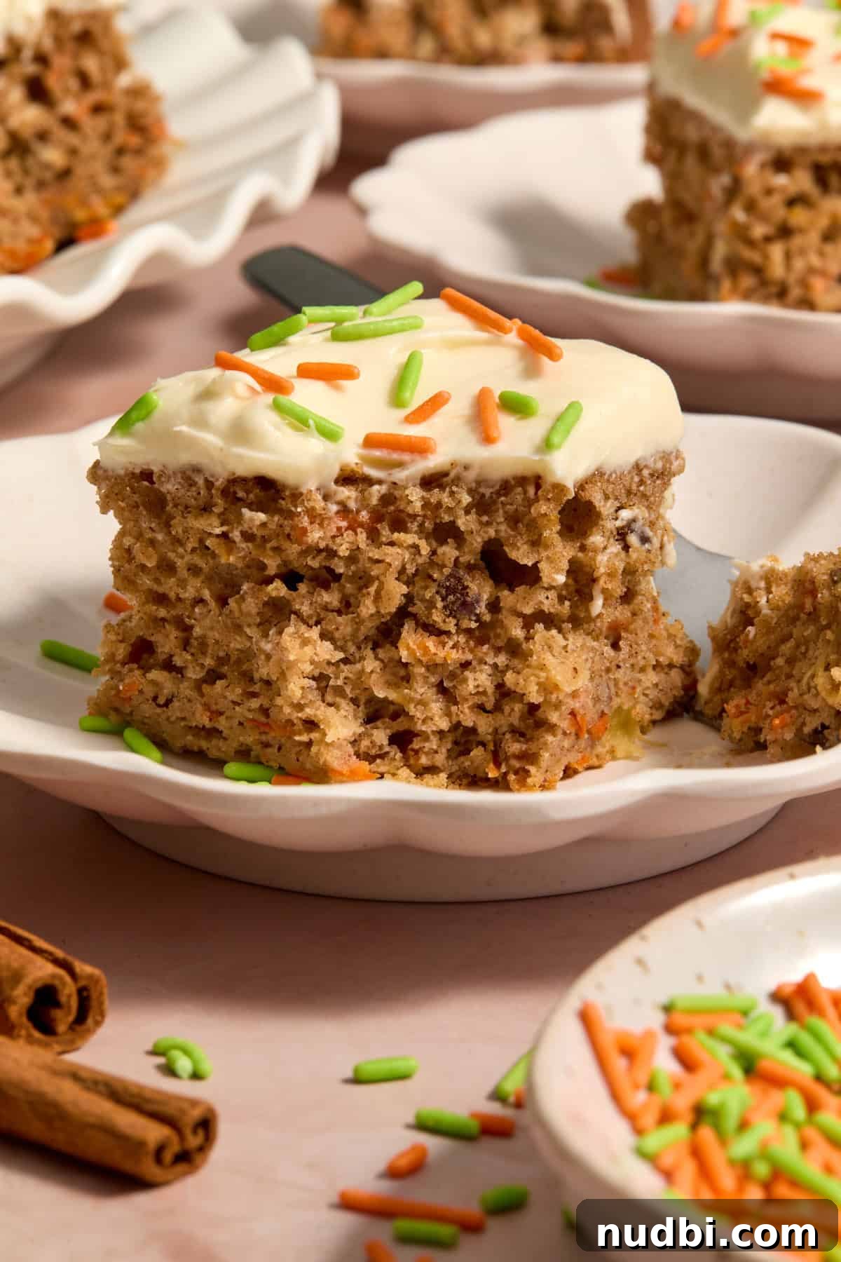Moist Carrot Cake Recipe Using Cake Mix 12 Slice of cake mix carrot cake with cream cheese frosting on plate.
