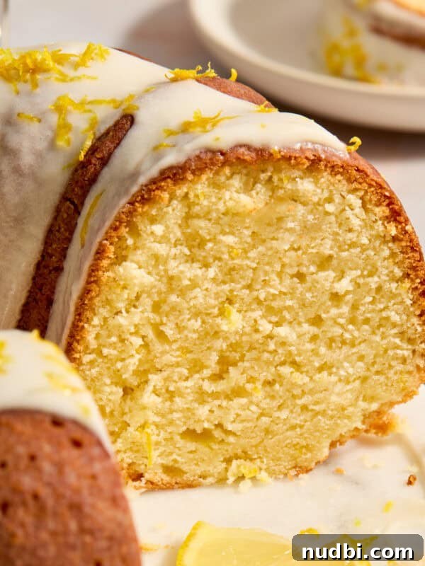 Moist Carrot Cake Recipe Using Cake Mix 15 Lemon bundt cake on cake plate with slice cut out to show texture of cake.