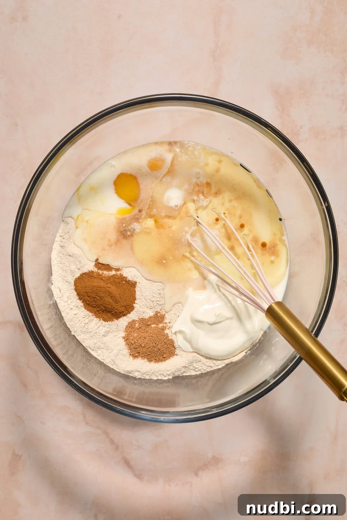 Moist Carrot Cake Recipe Using Cake Mix 4 Cake mix, milk, eggs, oil and other ingredients in glass bowl before mixing.