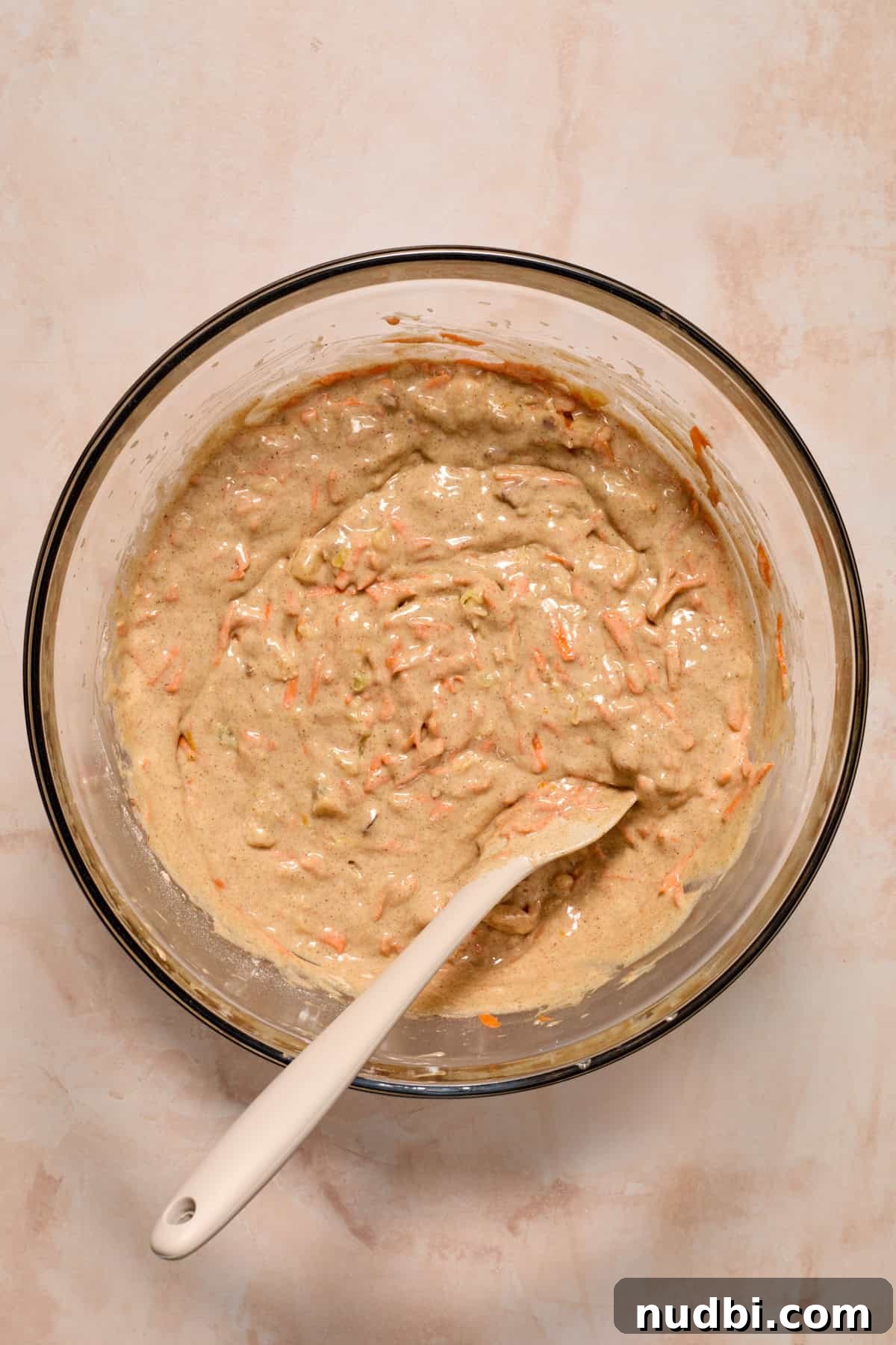 Moist Carrot Cake Recipe Using Cake Mix 7 Carrot cake batter mixture made from cake mix in bowl with spoon.