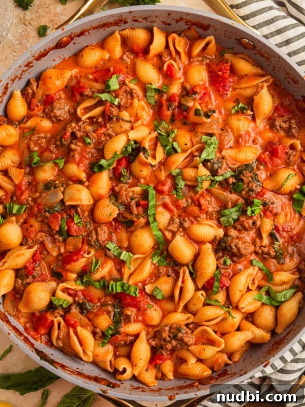 Creamy One-Pot Ground Beef Stroganoff Recipe 13 Ground beef pasta in skillet topped with basil.