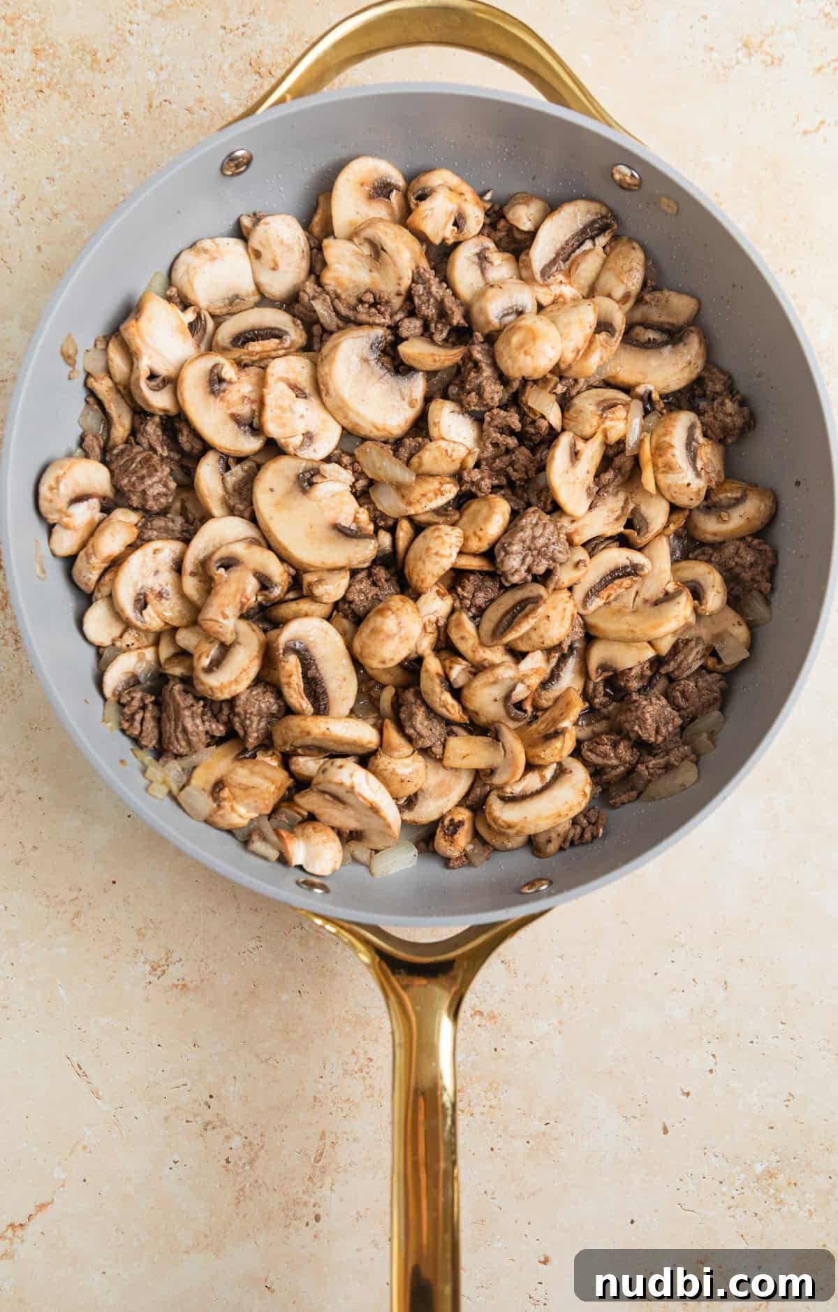 Creamy One-Pot Ground Beef Stroganoff Recipe 5 Mushrooms and browned ground beef in skillet.