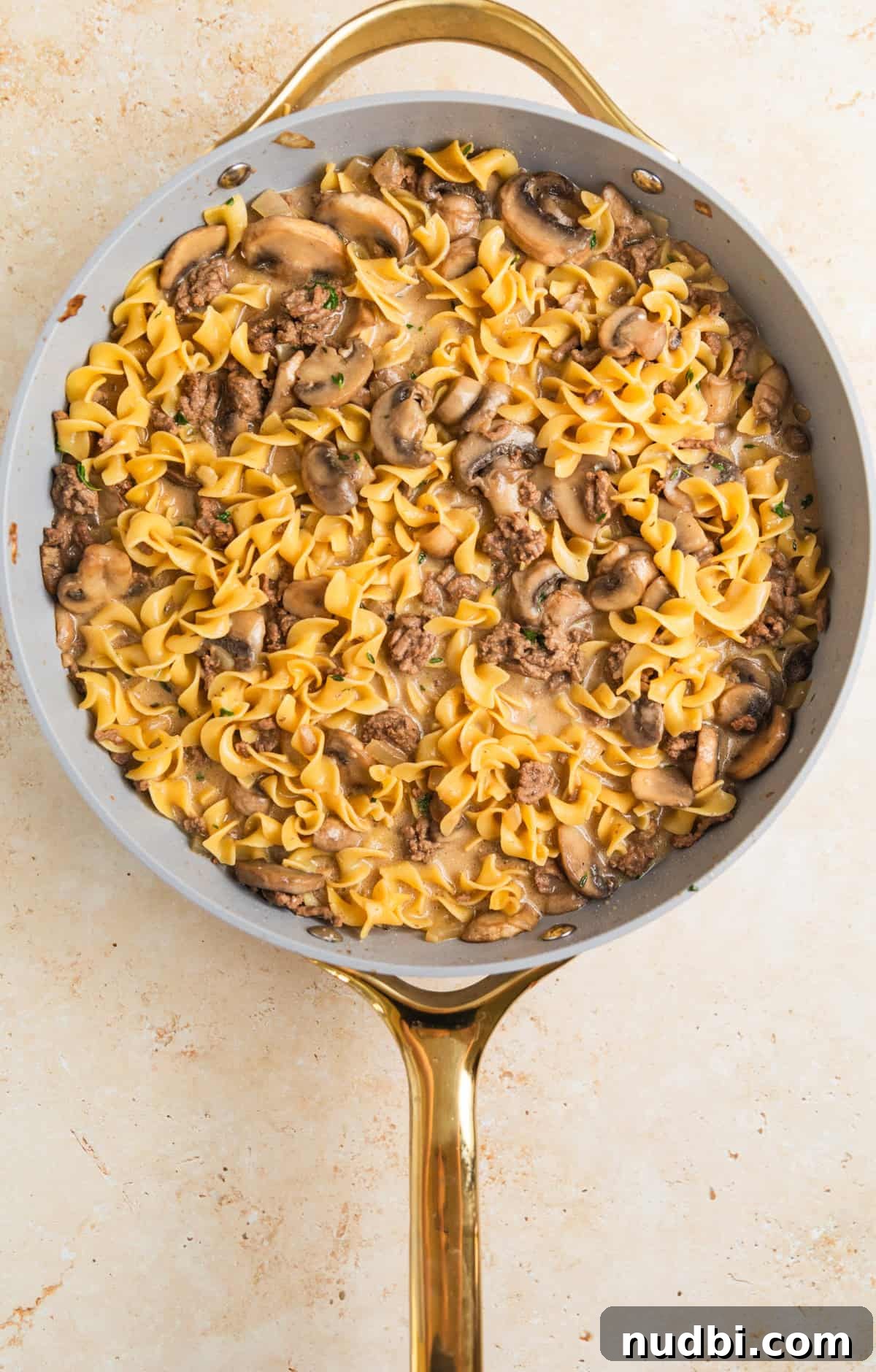Creamy One-Pot Ground Beef Stroganoff Recipe 9 Sour cream and cream cheese added to one-pot beef stroganoff in pan.