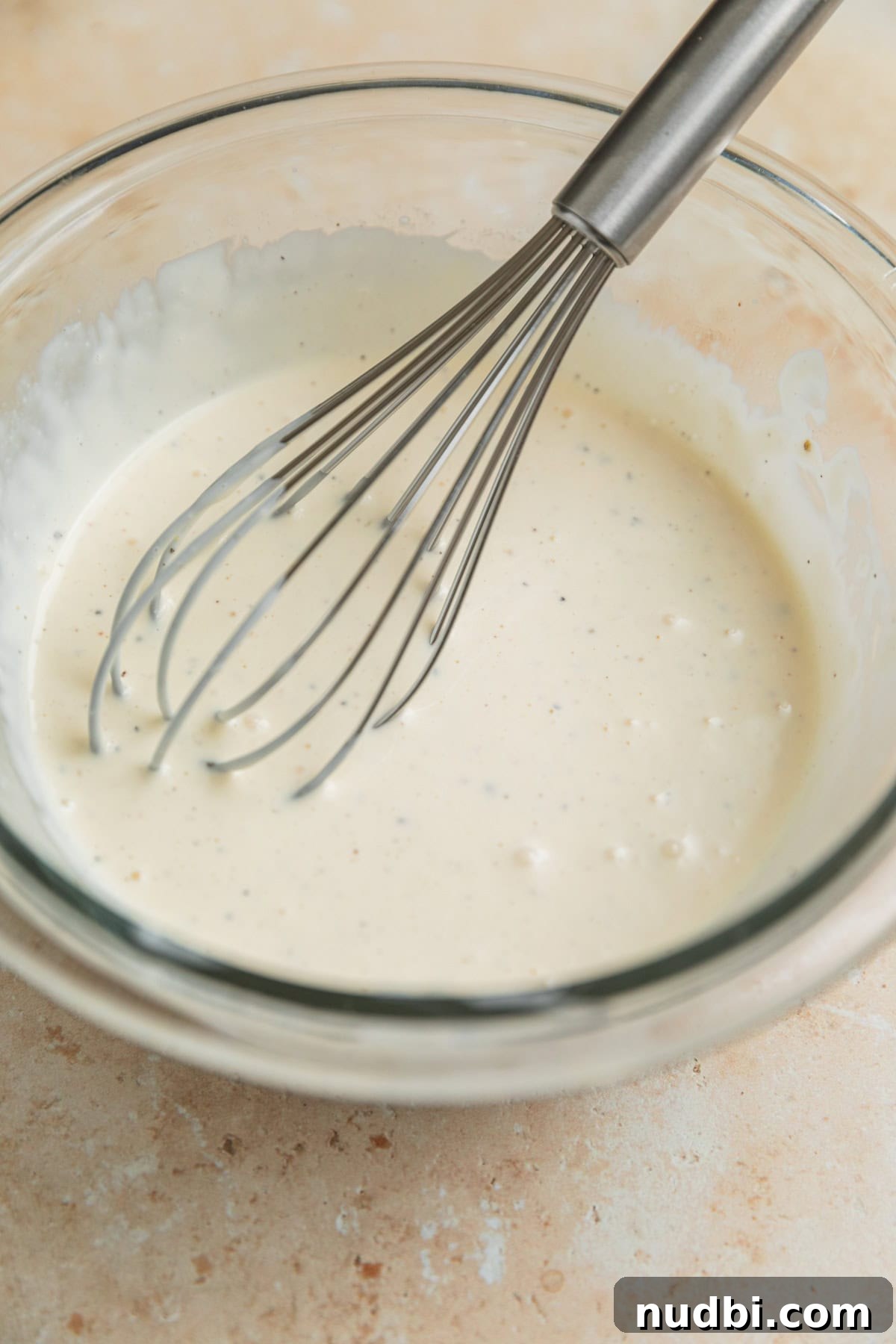 Crunchy Broccoli and Cauliflower Salad with Lemon-Dill Dressing 6 Creamy dressing in bowl with whisk.
