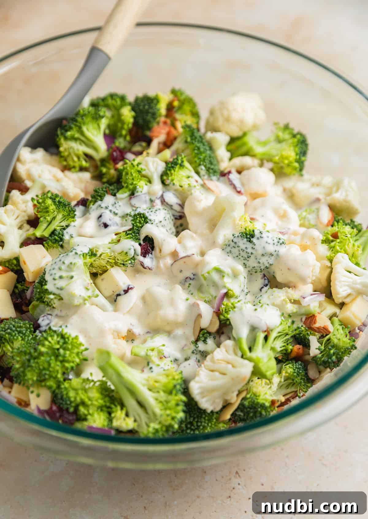 Crunchy Broccoli and Cauliflower Salad with Lemon-Dill Dressing 7 Salad dressing poured over top of broccoli and cauliflower salad ingredients.
