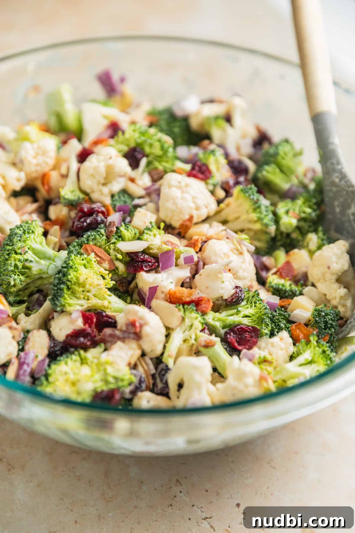 Crunchy Broccoli and Cauliflower Salad with Lemon-Dill Dressing 8 Salad in large mixing bowl with spoon propped in the bowl.