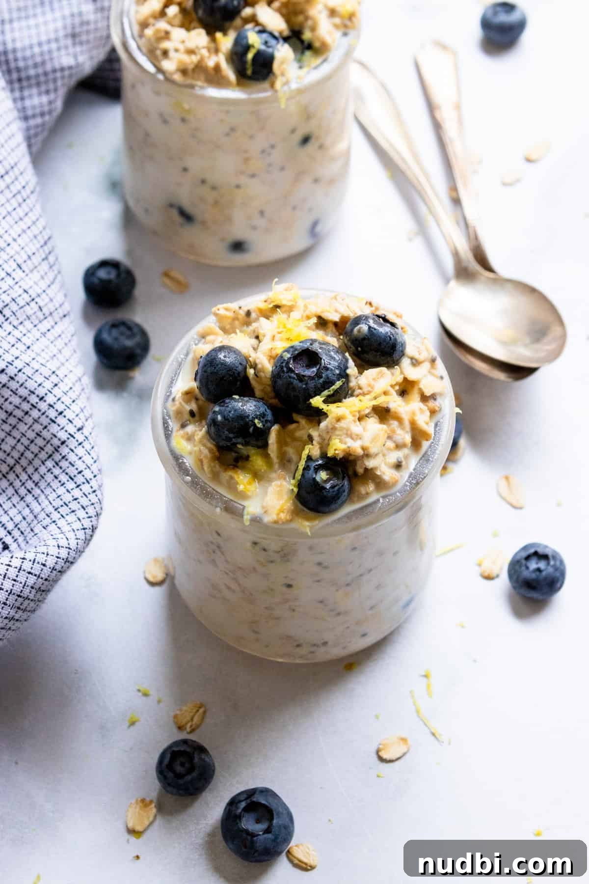 Blueberry Lemon Overnight Oats Recipe for Quick Make-Ahead Breakfast 2 Blueberry lemon overnight oats in jar with lemon zest and fresh blueberries.