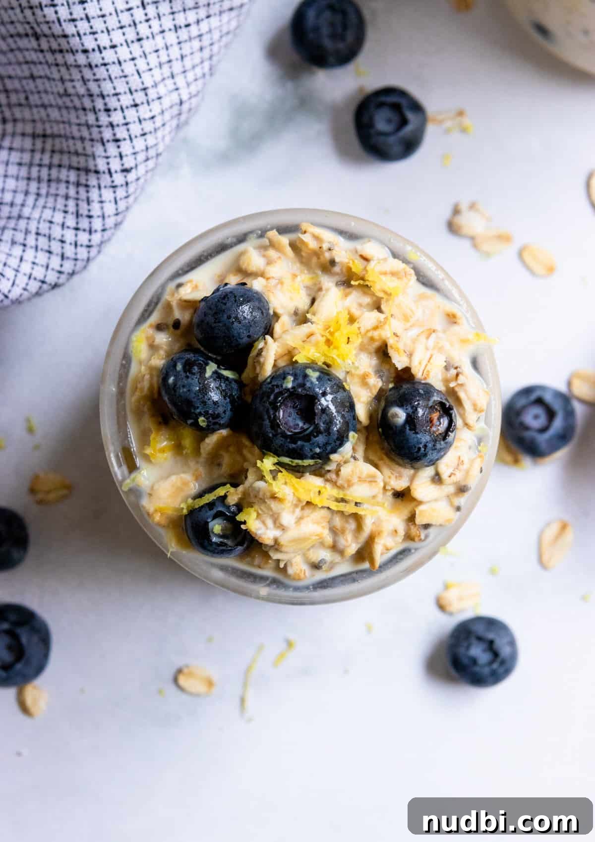 Blueberry Lemon Overnight Oats Recipe for Quick Make-Ahead Breakfast 3 Overhead shot of oatmeal with blueberries and lemon zest.