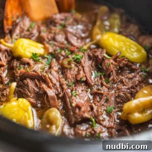 Mississippi Pot Roast in a Slow Cooker: Tender, Flavorful Recipe 12 Pot roast in crock pot with peppers and parsley.